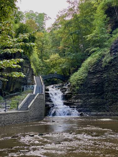 View of the waterfall and stone foot bridge