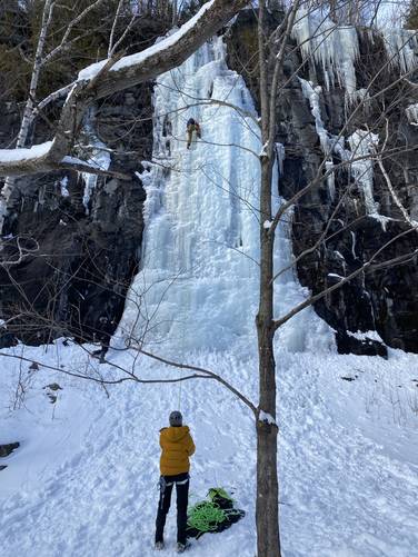 Ice climbers on frozen waterfall approx. 40-feet tall
