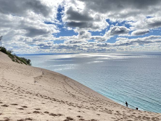 Hikers climbing up the dunes from Lake Michigan